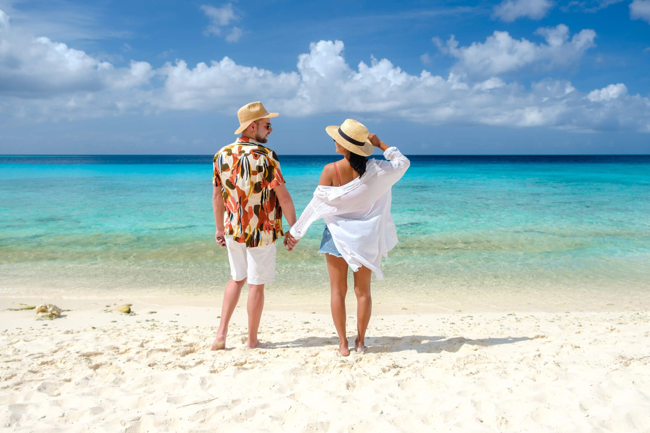 Couple holding hands on beach