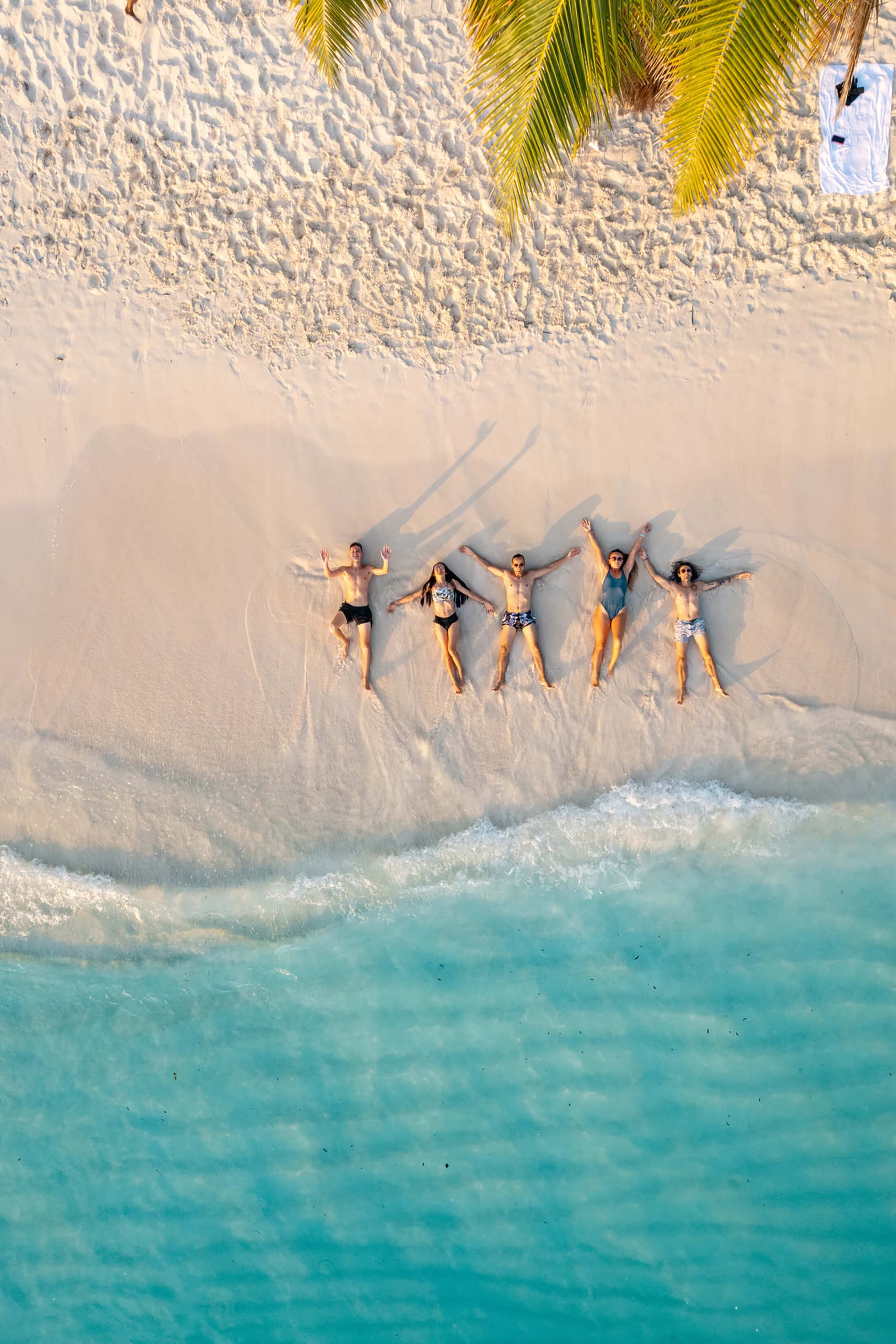 Group of friends laying on beach