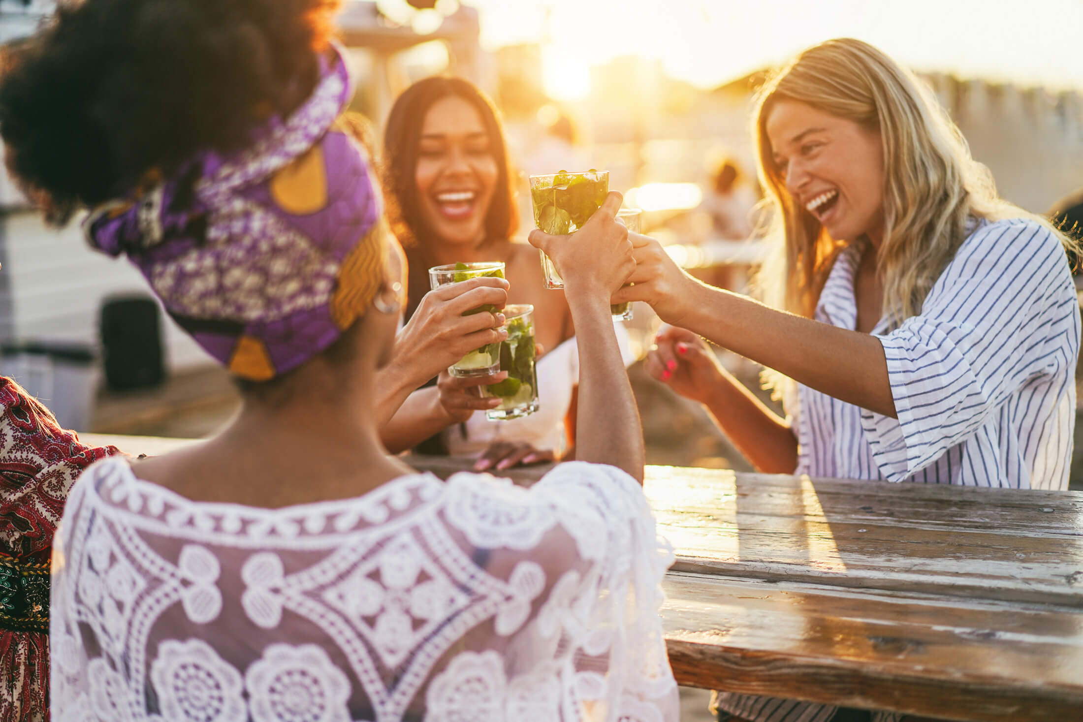Women clinking drinks