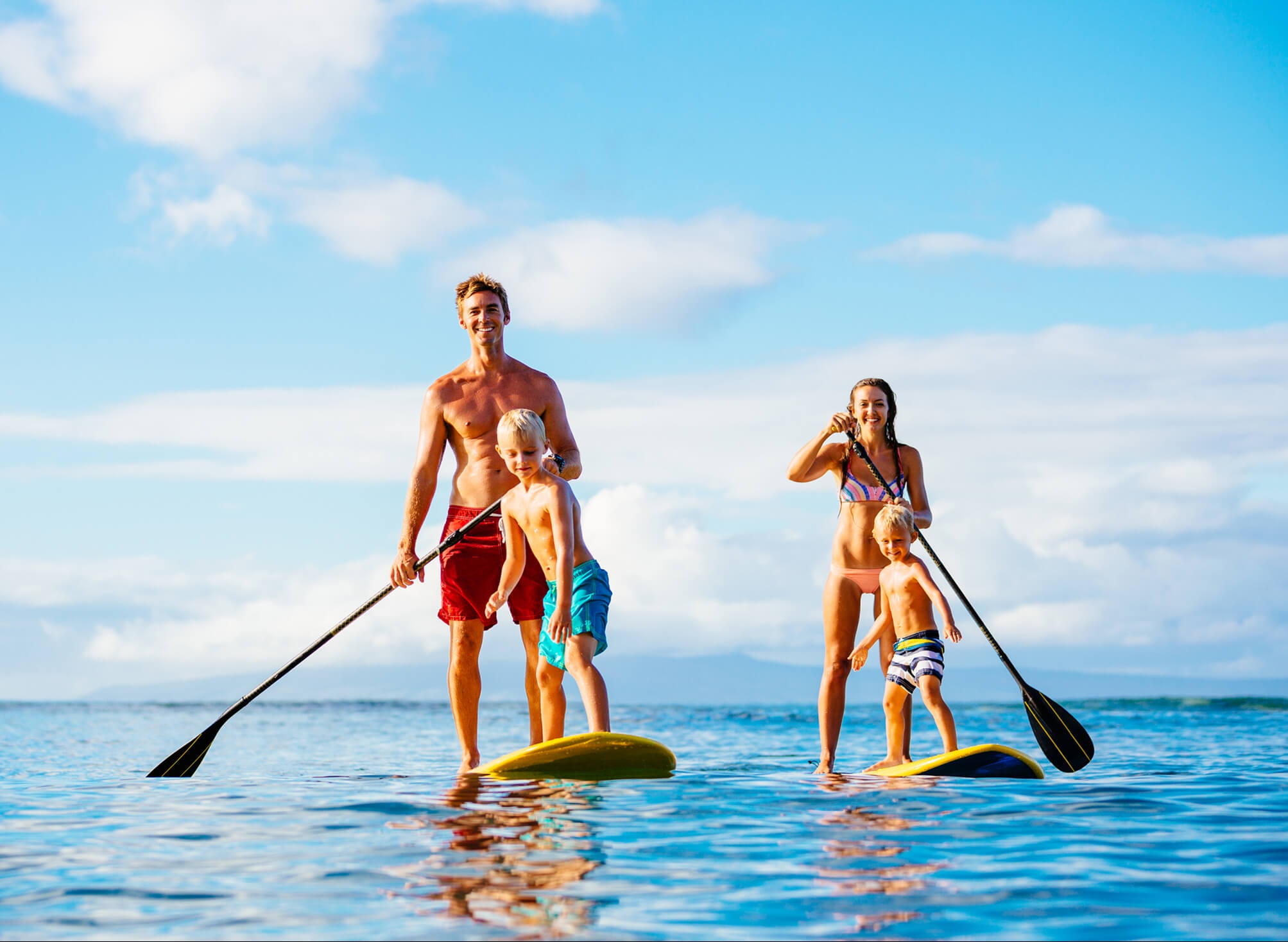 Parents with kids Paddle Boarding