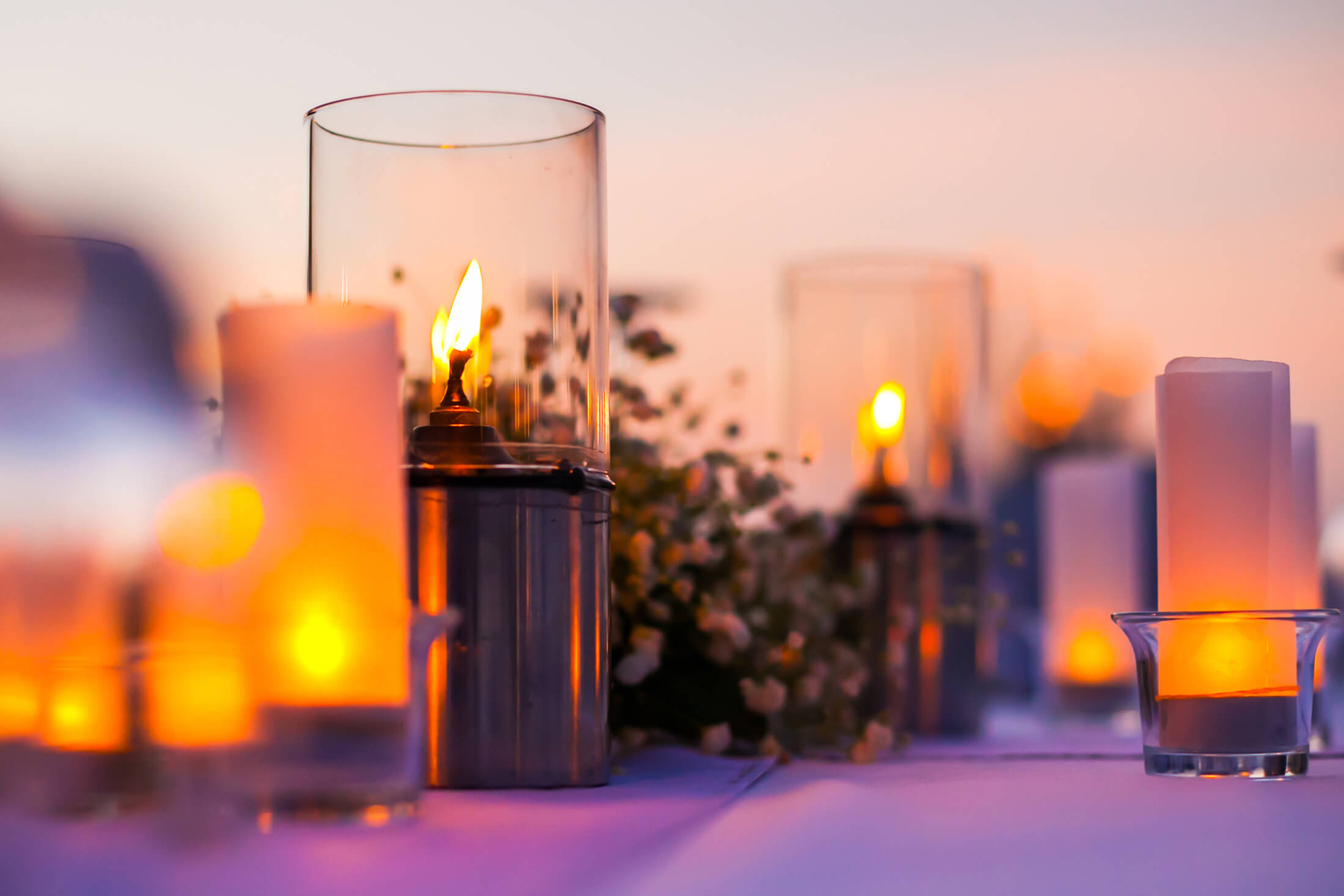Candles on table at sunset