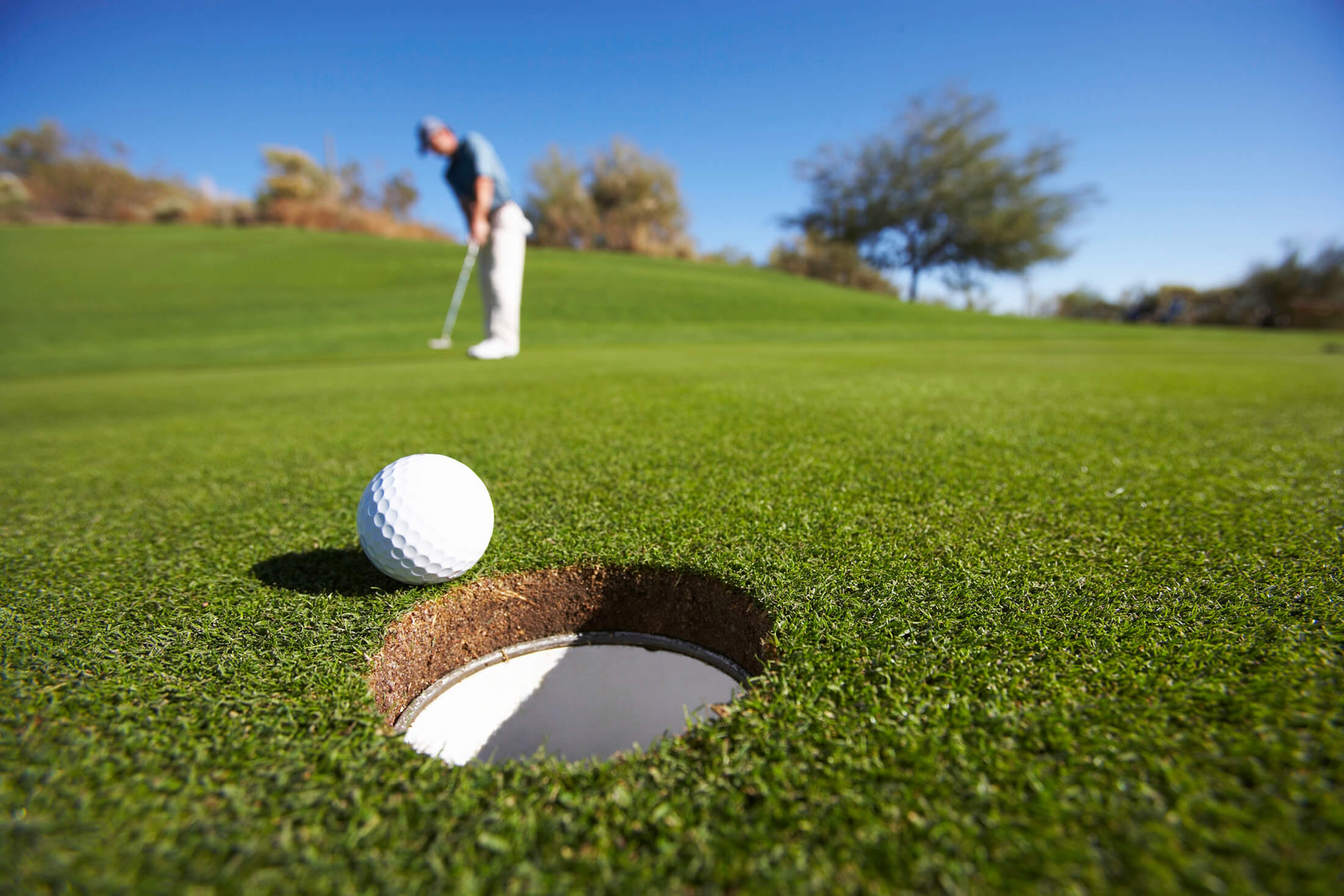 Golfer hitting put on the green