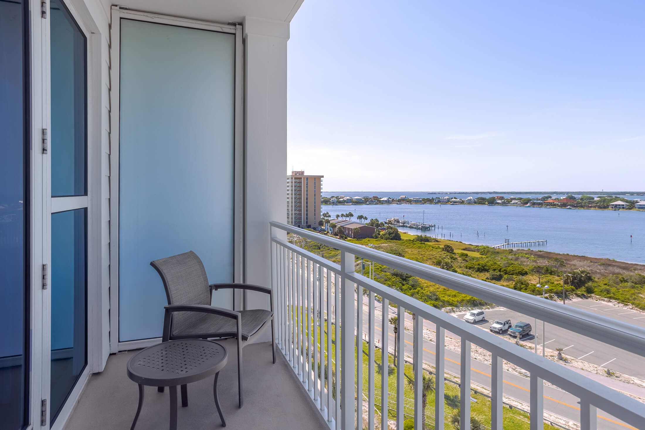 Patio with seating overlooking the ocean at Pensacola Beach Resort