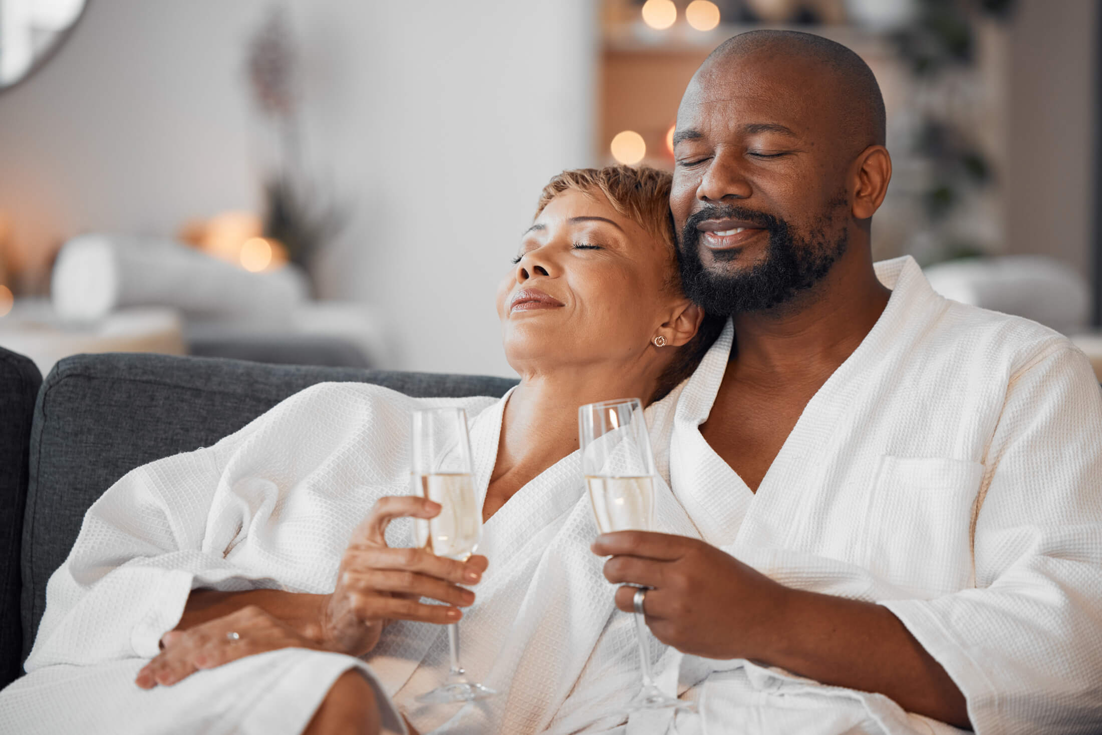 A couple enjoy drinks while in robes at Pensacola Beach Resort